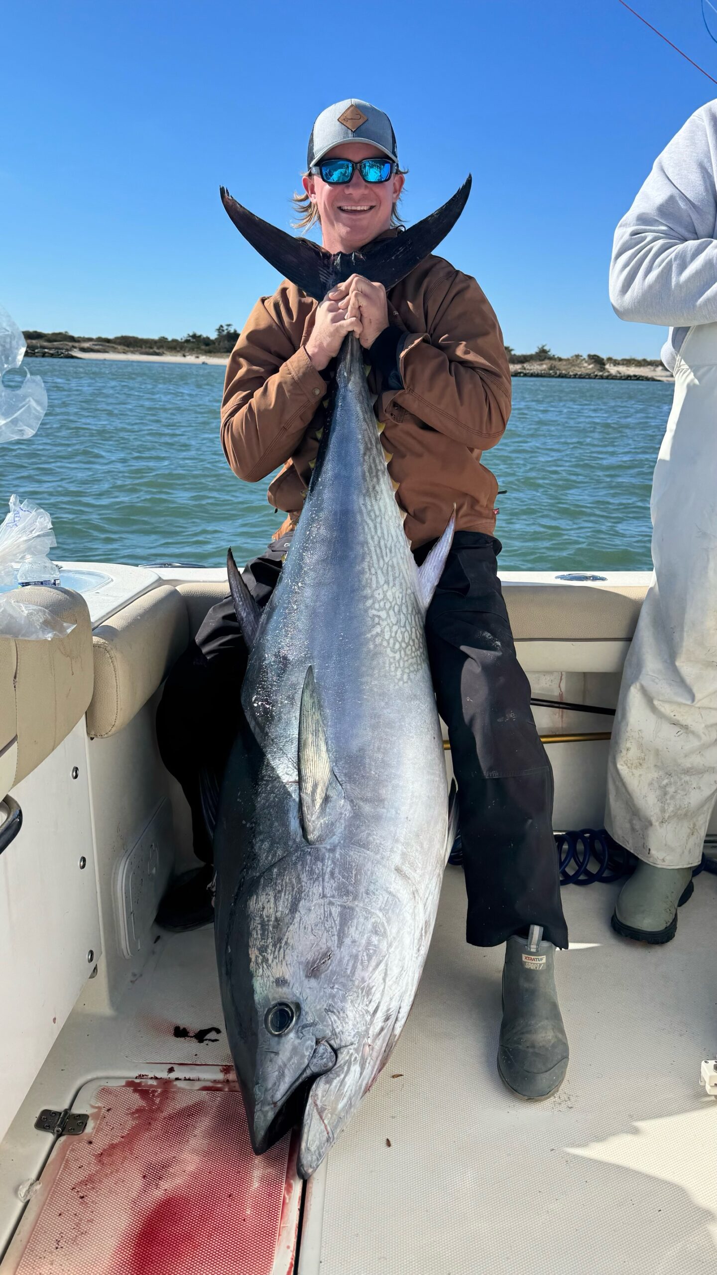 Photo of man on a boat with a large fish